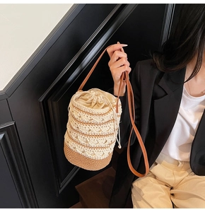 Detailed close-up of Bohemian woven bucket bag with drawstring closure and leather strap