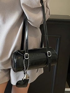 Minimalist black cylinder shoulder bag with glossy wax leather and heart pendant