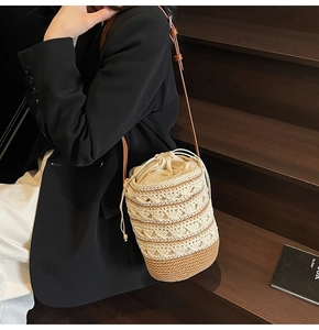Detail of bohemian woven bucket bag with drawstring closure and leather strap