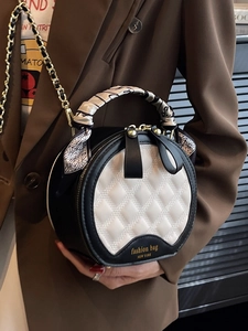 Quilted round crossbody bag in black and white with gold chain and silk scarf handle