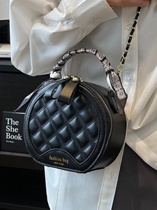 Elegant black quilted round handbag with decorative silk scarf handle and gold chain strap