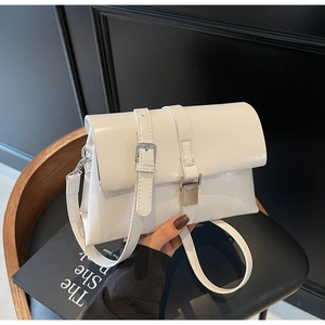 Close-up of minimalist cream white oil wax leather shoulder bag with silver buckle