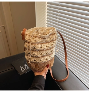 Close-up of Bohemian crochet bucket bag with hollow patterns and leather strap