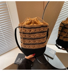 Detail of bohemian woven bucket bag featuring hollow pattern and drawstring closure