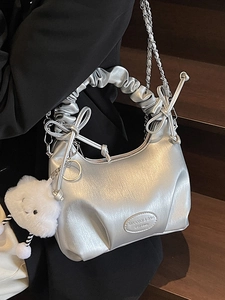 Silver metallic crescent handbag with pleated handle, bow decor and plush cloud charm