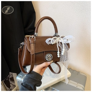 Brown faux leather crossbody bag with elegant pearl beads and white lace bow detail