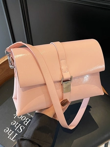 Pink oily leather shoulder bag with silver buckle in a minimalist vintage style