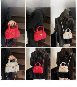 Detailed views of mini Boston bags in red suede and cream leather with metal logo