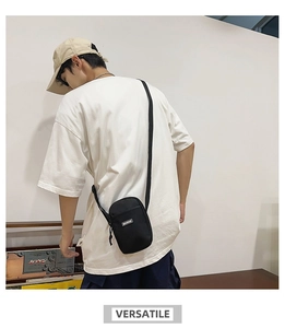 Fashionable black nylon mini crossbody bag shown on model for a trendy streetwear look