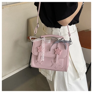 Detailed view of pink star crossbody bag with sweet lace and plaid bow decorations