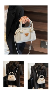 Detailed macro view of the light blue lychee pattern leather Boston bag with gold hardware