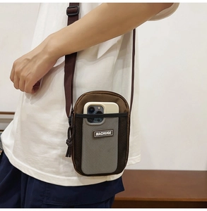 Brown canvas mini crossbody phone bag with mesh pocket and adjustable shoulder strap
