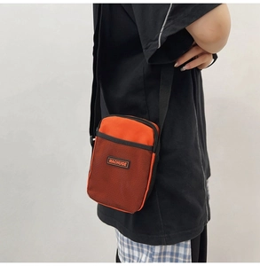 Detail view of the mini crossbody bag with MACHUGE logo and durable mesh fabric