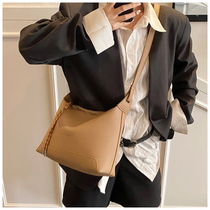 Detail view of khaki crossbody tote bag with lychee texture and adjustable wide strap
