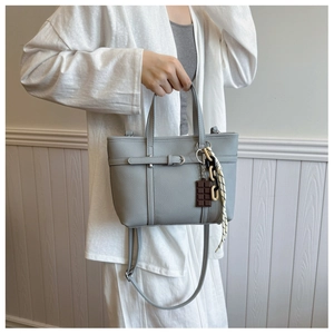 Grey litchi grain bucket bag with metal buckle and chocolate pendant detail