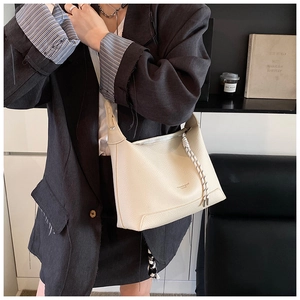 Detail of lychee pattern cream tote bag featuring Roman and Bags London text and woven zipper