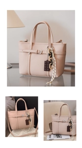 Detail of lychee pattern leather bucket bag with decorative charms and adjustable strap
