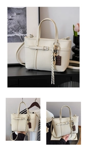Detail of beige lychee textured bucket bag with striped silk scarf and charm