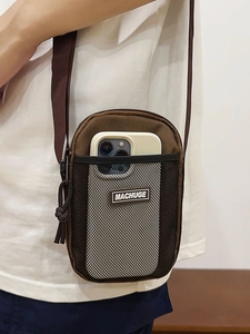 Brown nylon mini crossbody phone bag with front mesh pocket and adjustable strap