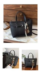 Detail view of black lychee grain bucket bag with decorative buckle and charm accessory