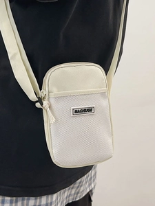 Minimalist beige nylon mini crossbody phone bag with mesh pocket and adjustable strap