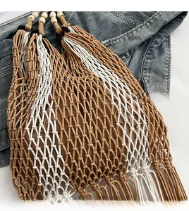 Close-up of woven tote bag featuring wooden beads, two-tone mesh, and bottom tassels