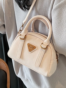 Minimalist litchi grain leather Boston bag in beige with top handle and shoulder strap