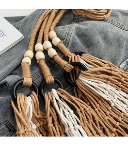 Macro detail of bohemian woven tote bag with white wooden beads and dark brown rings