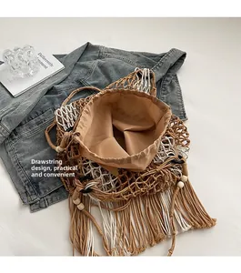 Detail view of the drawstring closure design on this woven boho tote bag with tassels