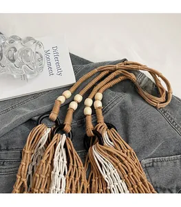 Detail of hollow woven tote bag featuring brown cotton rope and light wood bead accents
