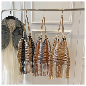 Detailed close-up of bohemian woven tote bags with hollow mesh design and long fringe tassels