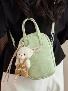 Sac bandoulière vert menthe texture litchi avec poignée et charmant ours en peluche