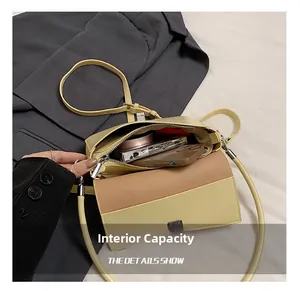 Macro view of the internal capacity and storage space of this yellow square shoulder bag
