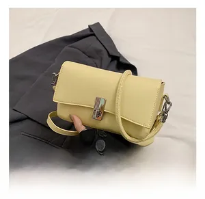 Detail view of smooth cream yellow oil wax leather bag with elegant silver metallic twist lock
