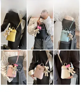 Collage showing colorful mini cylinder crossbody bags with plush puppy charms and straps