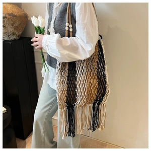 Bohemian woven tote bag detail showing tricolor stripes, long tassels, and wood bead strap