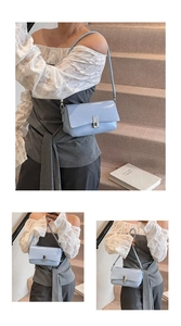 Detail of light blue glossy leather square bag featuring elegant silver metal buckle