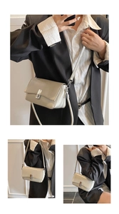 Detailed close-up of a cream oil-wax leather shoulder bag with a silver metal clasp