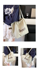 Detail of light green canvas tote bag with brown Beach print and drawstring closure