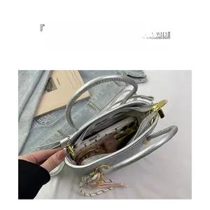Interior view of silver PU bucket bag showing large capacity and internal zipper pocket