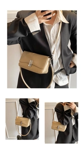Detail view of smooth oil wax leather surface and silver metal buckle on square crossbody bag