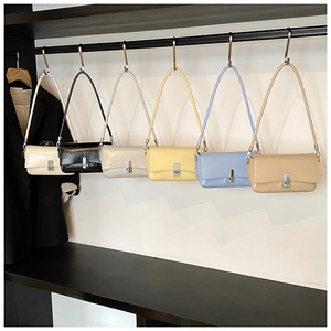 Selection of six oil wax leather baguette bags in neutral colors with metallic buckles