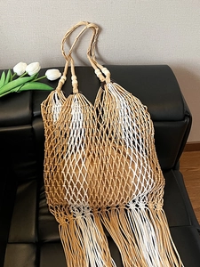 Bohemian woven tote bag with fringe tassels and wooden beads for summer beach vacations