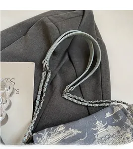 Detail of blue tote bag with traditional Chinese landscape print and metal chain strap