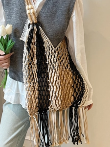 Bohemian woven tote bag with vertical stripes and long tassels for beach vacations
