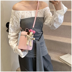 Detail of light pink lychee texture bucket bag with Snoopy plush doll charm and zipper