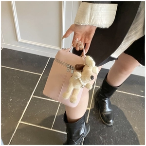 Pink lychee texture handbag with cute poodle plush charm and silver dual zippers