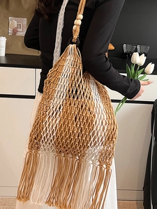 Ethnic style macrame tote bag with long tassels and wooden bead strap for beach holidays