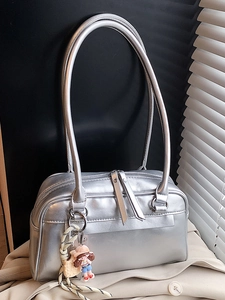 Chic silver Boston bag for women with dual zippers and a cute cartoon charm accessory