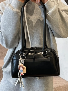 Glossy black Boston shoulder bag with a cute sailor girl charm in a staircase setting